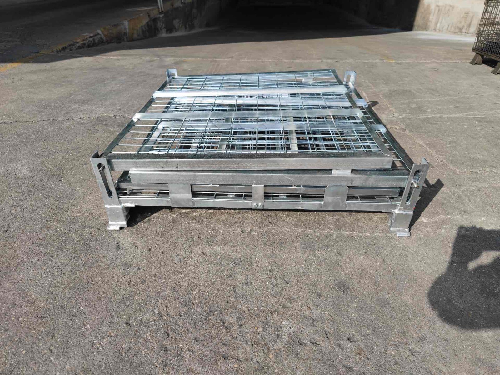 Wire mesh cage in folded configuration — compact storage