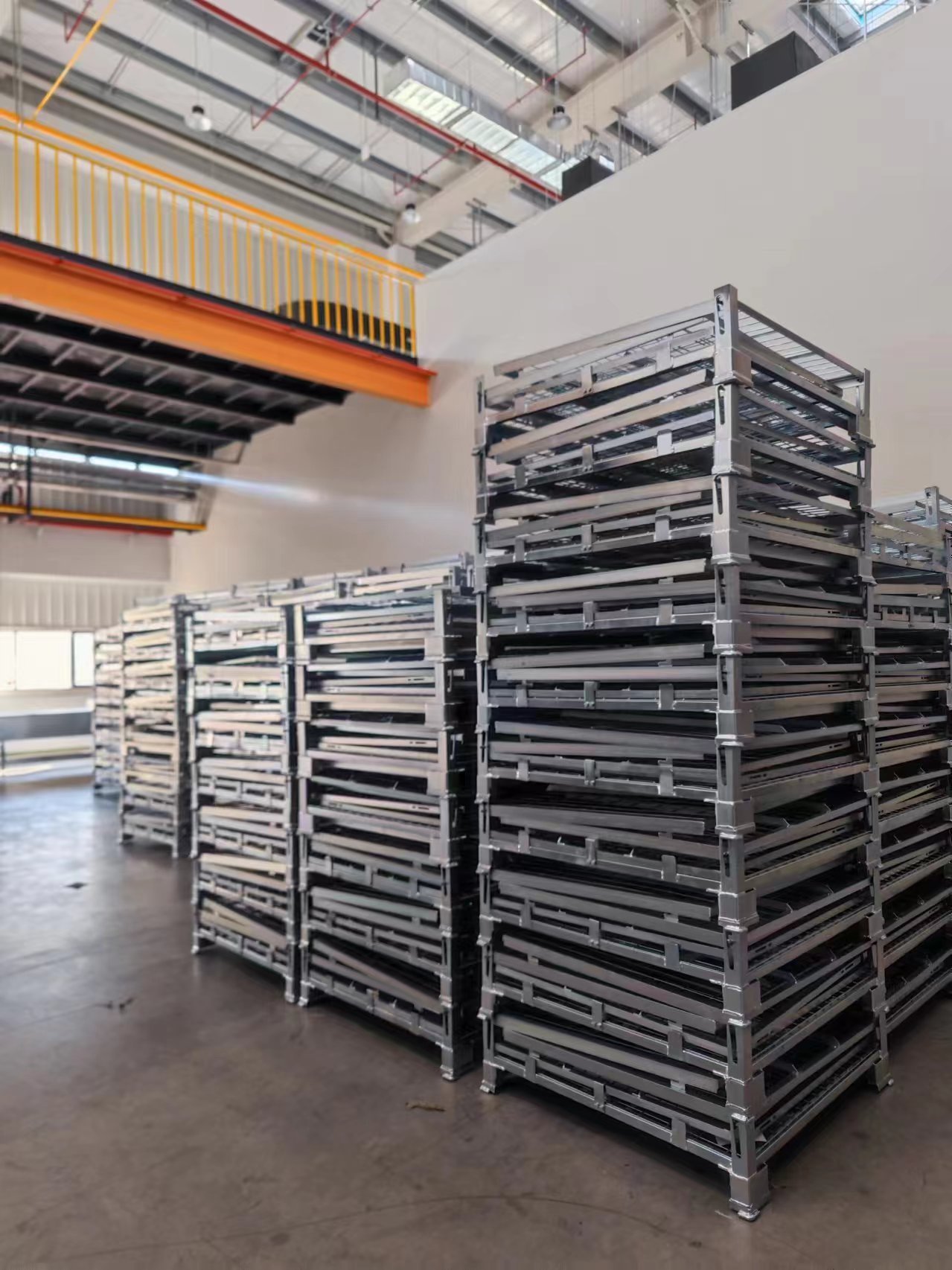 Multiple folded wire mesh cages stacked in batch storage